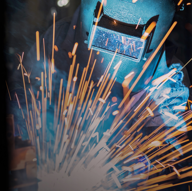 A welder welding and creating sparks