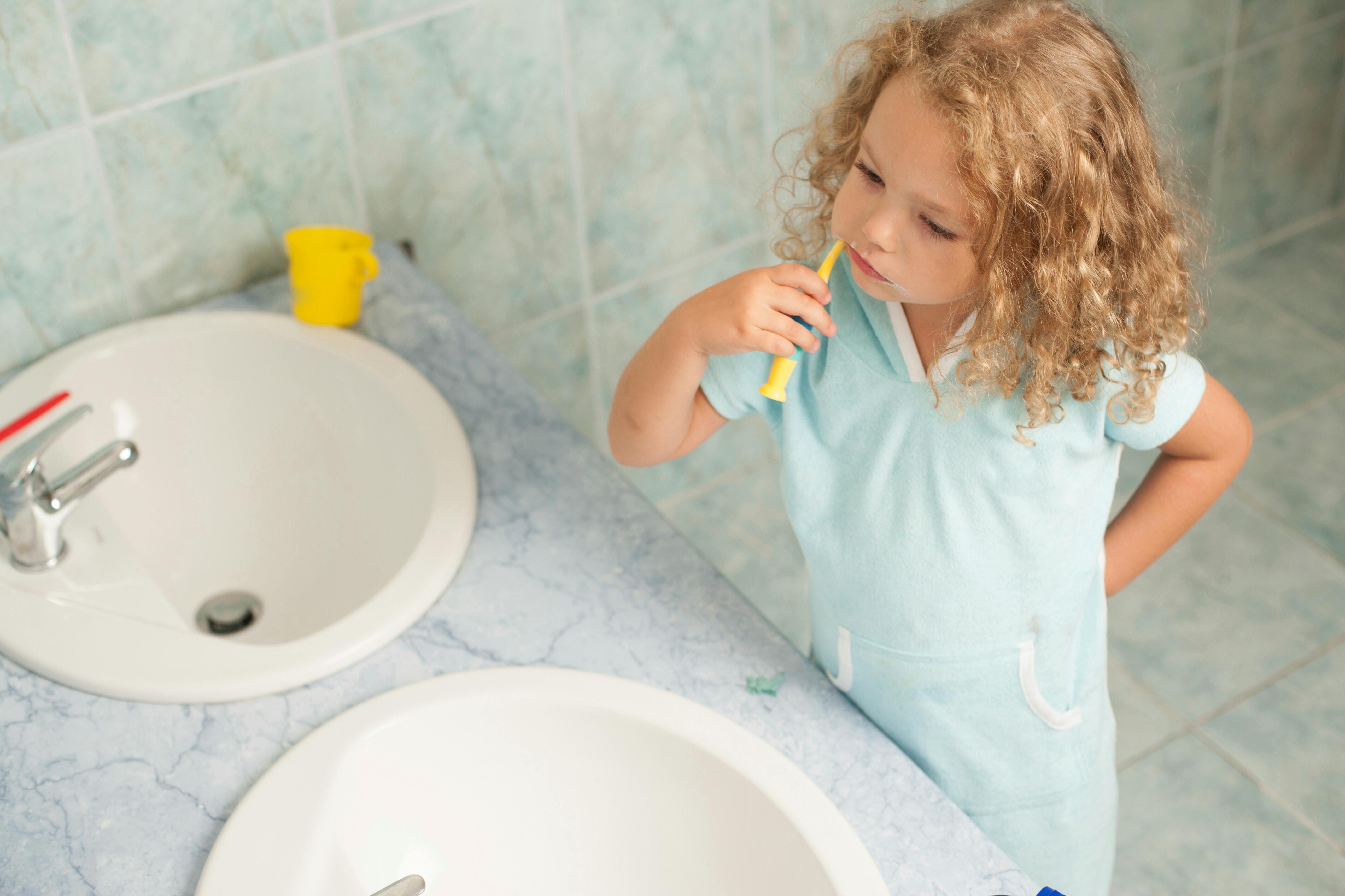 A young girl brushing her teeth